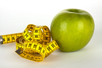 Image showing fresh green apple with yellow measure tape 