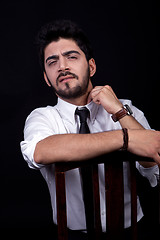 Image showing young successful business man with a suit isolated on black background