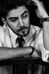 Image showing young successful business man with a suit isolated on black background