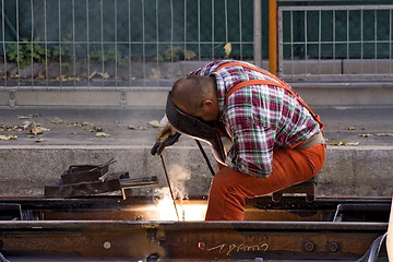 Image showing Construction Worker Fixing Rails (Landscape)