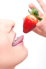 Image showing close-up woman´s lips and a strawberry