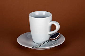 Image showing white coffe cup with coffe beans and a silver spoon