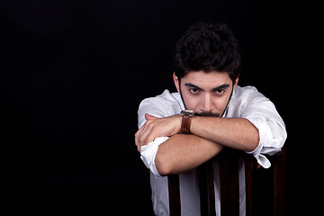 Image showing young successful business man with a suit isolated on black background