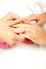 Image showing feminin hands with a treatment doing a manicure closeup