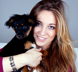 Image showing young beatiful girl with a cute little dog having fun