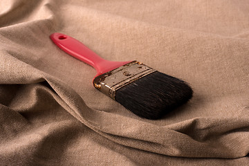 Image showing Old brush with red cape.