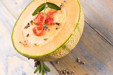 Image showing fresh melon soup with parma ham and lavender flower