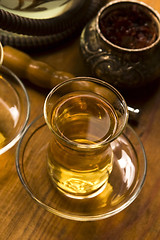 Image showing Cup of turkish tea and hookah served in traditional style