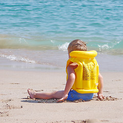 Image showing Liitle boy on the beach in lifejacket
