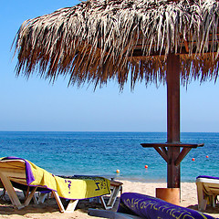 Image showing Sunchairs and umbrellas on Beach