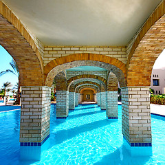 Image showing  Swimming pool under bridge in resort