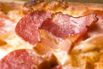 Image showing Italian pizza with bacon, salami and mozzarella cheese