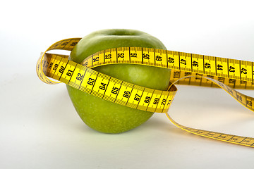 Image showing fresh green apple with yellow measure tape 