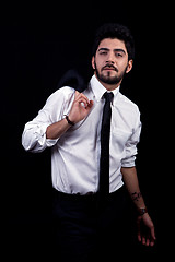 Image showing young successful business man with a suit isolated on black background