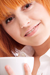 Image showing beautiful woman with red hair and a cup of tea