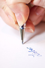 Image showing womans hand is writing a letter with a pen 