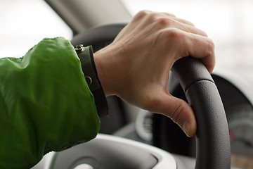 Image showing hand on wheel man is driving a car