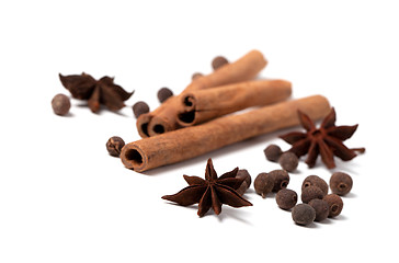 Image showing Cinnamon sticks, anise stars and black peppercorns