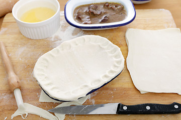 Image showing Putting pastry on a pie