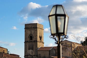 Image showing Medieval church and street lantern at sunset