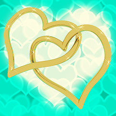 Image showing Gold Heart Shaped Rings On Turquoise Bokeh Representing Love And