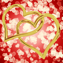 Image showing Gold Heart Shaped Rings On Red Bokeh Representing Love And Roman