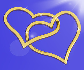 Image showing Gold Heart Shaped Rings On Blue Representing Love And Romance