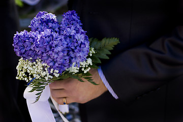 Image showing Man hold flowers