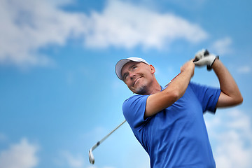 Image showing golfer shooting a golf ball 