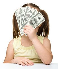 Image showing Cute little girl with dollars