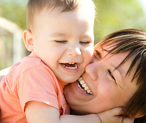 Image showing Portrait of a mother hugging her son