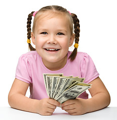 Image showing Cute cheerful little girl with paper money