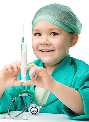 Image showing Cute little girl is playing doctor with syringe