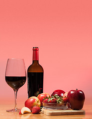 Image showing Red wine bottle and fruit with glass