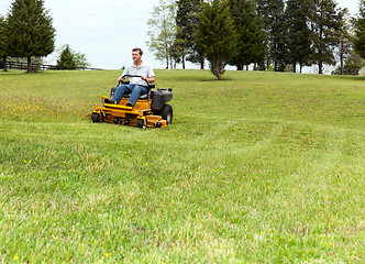 Image showing Senior man on zero turn lawn mower on turf