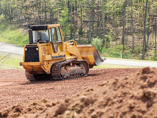 Image showing Large earth mover digger clearing land