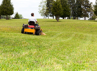 Image showing Senior man on zero turn lawn mower on turf