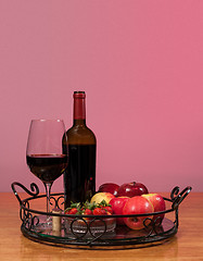 Image showing Red wine bottle and fruit with glass