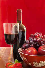 Image showing Red wine bottle and fruit with glass