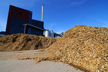 Image showing bio power plant with storage of wooden fuel against blue sky