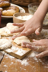 Image showing Detail of hands kneading dough