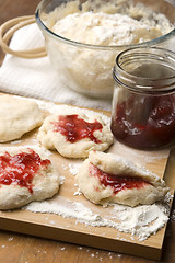 Image showing Dough with marmelade on wooden board