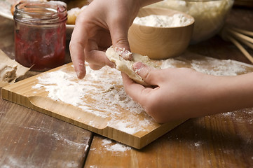 Image showing Detail of hands kneading dough