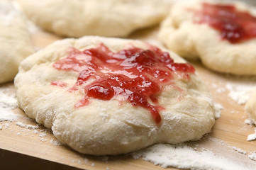 Image showing Dough with marmelade on wooden board
