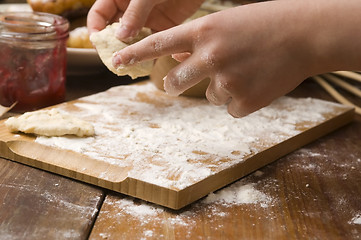 Image showing Detail of hands kneading dough