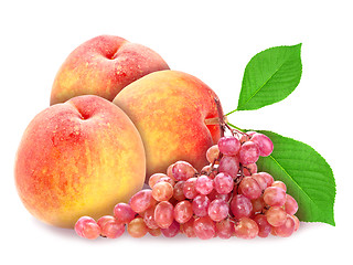 Image showing Red grape and peachs with green leaf