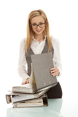 Image showing business woman with folder on desk workin isolated on white background