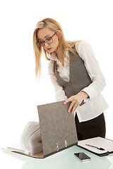 Image showing business woman with folder on desk workin isolated on white background