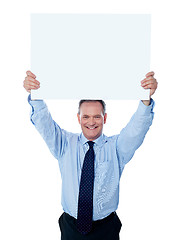Image showing Businessman holding a blank billboard over the head