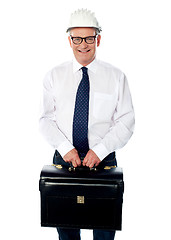 Image showing Handsome senior builder holding briefcase